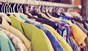 Image: rack of colorful clothing. Topic: Finding New Life for Old Clothes